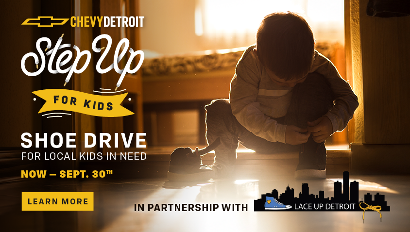 Chevy Detroit Step Up for Kids Shoe Drive for local kids in need, running now through September 30th. Learn More button. In partnership with Lace Up Detroit. Photo of a young child sitting on the floor in a sunlit doorway, tying their shoe.