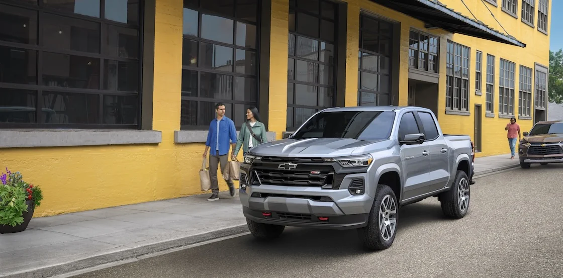 Silverado Colorado parked by couple with shopping bags